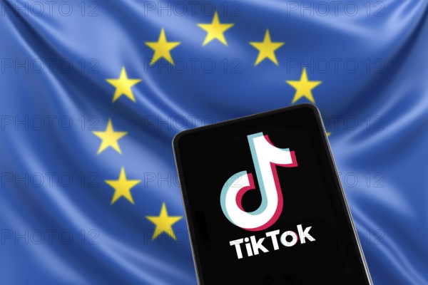 TikTok logo from China with EU European Union flag social media on a mobile phone in Stuttgart, Germany, Europe