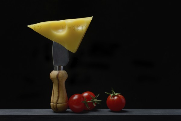 A piece of Swiss Emmental cheese on a cheese knife