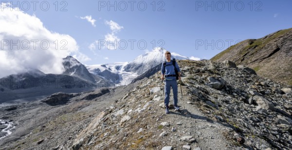 Mountaineer on a hiking trail, behind glacier Glacier de Cheilon and summit Mont Blanc de Cheilon, Valais Alps, Valais, Switzerland, Europe