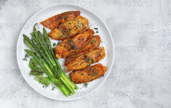 Fried fish fillet, tilapia with asparagus, homemade, no people