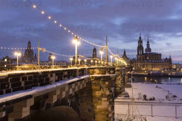 Old town across the Elbe in snow with fairy lights on the Augustus Bridge, Frauenkirche, Ständehaus, and Hofkirche, Dresden, Saxony, Germany, Europe
