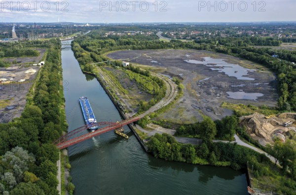 Essen, North Rhine-Westphalia, Germany - FREIHEIT EMSCHER urban development project. The cities of Essen and Bottrop, together with the owner RAG Montan Immobilien GmbH, want to transform former mining sites on the Rhine-Herne Canal and Emscher into an urban centre with commerce and industry, residential areas as well as green spaces and leisure facilities on the waterfront. The so-called nucleus, consisting of the Sturmshof site (left) on the Bottrop side of the Rhine-Herne Canal and the Coelln-Neuessen harbour (right) on the Essen side, plays a special role here
