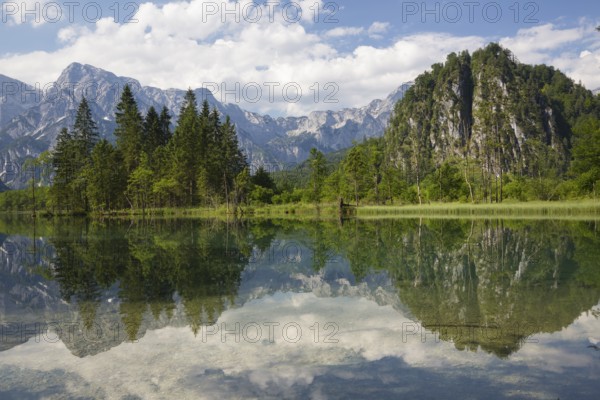 Lake Almsee in summer with totally smooth surface showing reflexion of the mountain Ameisstein