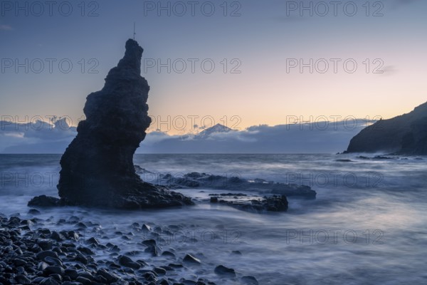 Before sunrise on the beach at Playa de La Caleta. Rocks and sea. Tenerife and the Teide in the background. Long exposure. La Gomera, Canary Islands, Spain, Europe