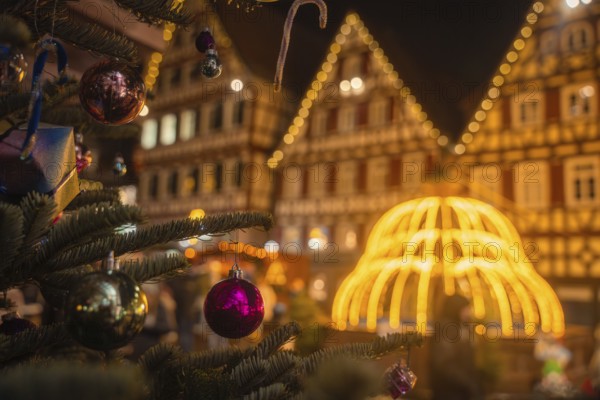 A decorated Christmas tree in front of brightly lit half-timbered houses at night, Calw Christmas market, Black Forest, Germany, Europe