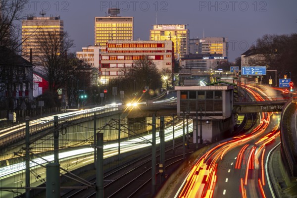Motorway A40, Ruhr expressway, heavy traffic jam, rush hour, city passage in Essen, skyline of the city centre, underground line between the lanes, Hobeisenbrücke stop, North Rhine-Westphalia, Germany, Europe