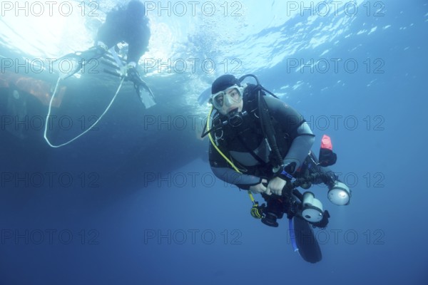 Diver under water with complete equipment waiting until the ladder back to the dive boat is free, dive site marine reserve Cap de Creus, Rosas, Costa Brava, Spain, Mediterranean Sea, Europe
