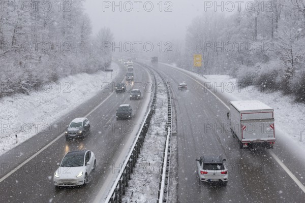Vehicles on a snow-covered motorway, surrounded by a wintry atmosphere and dense trees, Winnenden, Baden-Württemberg, Germany, Europe