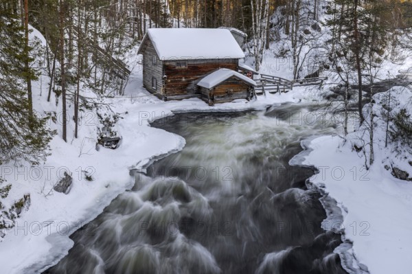 Old wooden Myllykoski water mill along the river Kitkajoki in winter, Oulanka National Park, Northern Ostrobothnia, Norra Österbotten, Finland, Europe