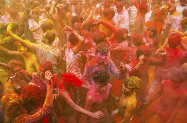 Revellers smear with Gulal or coloured powder and dance to play Holi, the Hindu spring festival of colours, on March 14, 2025 in Guwahati, India, Asia
