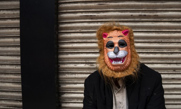 A person wears a mask to play Holi, the Hindu spring festival of colours, on March 14, 2025 in Guwahati, India, Asia