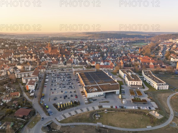 A town with many houses, a church tower and a large car park in the evening light, Weil der Stadt, Böblingen district, Germany, Europe
