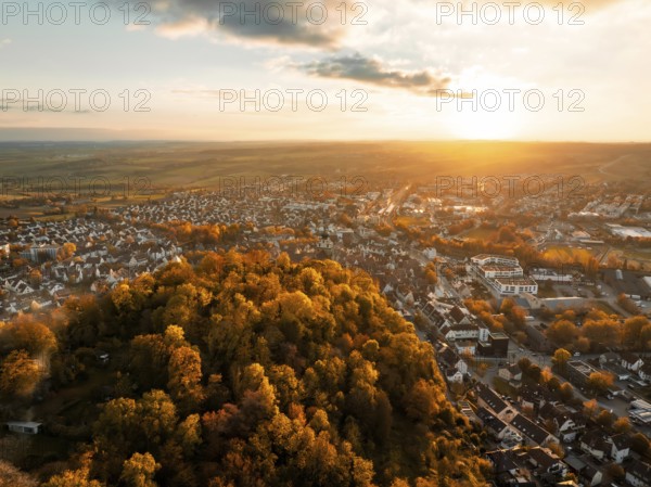 View of a town and surrounding forests at sunset, golden autumn colours, Herrenberg, Germany, Europe