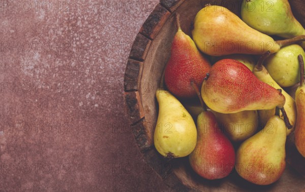 Pears, Duchess variety, small pears, early harvest, in a wooden plate, top view, no people