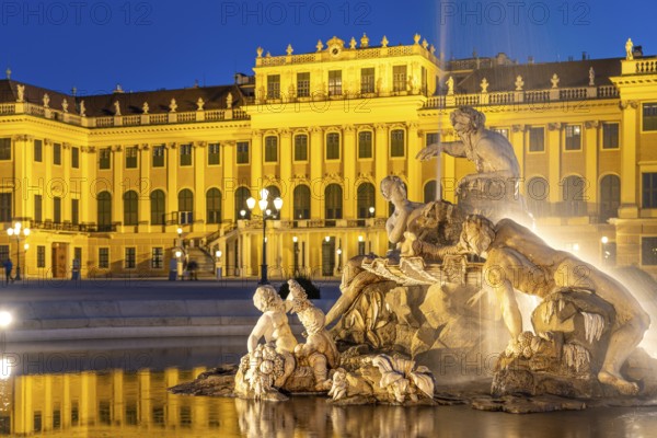 Fountain in the courtyard of honour at Schönbrunn Palace at dusk, UNESCO World Heritage Site in Vienna, Austria, Europe