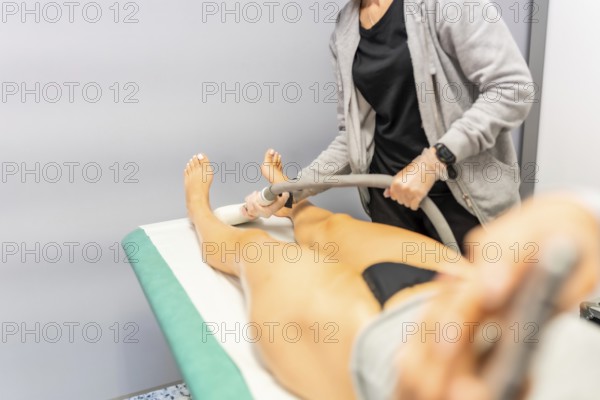 Removing hair on legs of a woman using modern laser technology