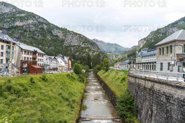 View of the old train station of Canfranc in the Aragonese Pyrenees next to the river. Spain