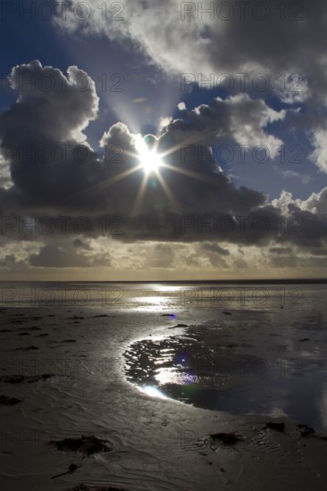 Sunburst through the clouds over the beach, South Shore, Blackpool, England, United Kingdom, Europe