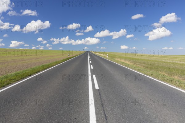 Straight country road, B173 between Dresden and Freiberg, without cars, blue sky with fair weather clouds, Wilsdruff, Saxony, Germany, Europe