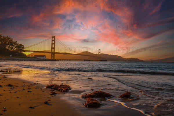 Gorgeous orange sunset with pink clouds over the Golden Gate in San Francisco, California. United States