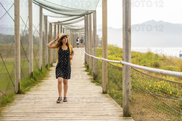Summer vacation lifestyle. Young and adventurous Caucasian girl enjoying the summer walking alone along the beach