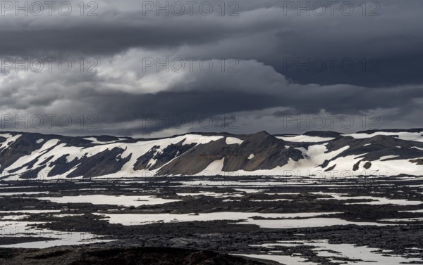 Snow-covered volcanic landscape with volcanic sand and petrified lava, crater of Askja volcano, Icelandic highlands, Iceland, Europe