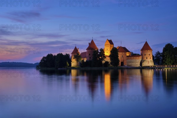 Night view of Trakai Island Castle in lake Galve illuminated in the evening, Lithuania, Europe