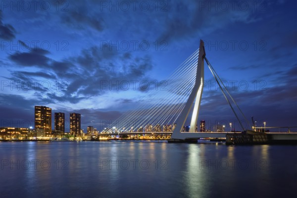 Erasmus Bridge (Erasmusbrug) and Rotterdam skyline illuminated at night. Rotterdam, Netherlands