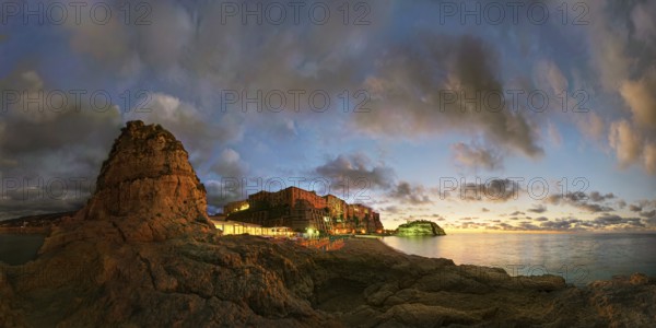 Panorama on the beach Lido Le Roccette Club Tropea with the old town of Tropea situated on rocks of sandstone and the medieval church Santuario di Santa Maria dell Isola at sunset and luminous cloudy sky, Tropea, Vibo Valentia, Calabria, Southern Italy, Italy, Europe