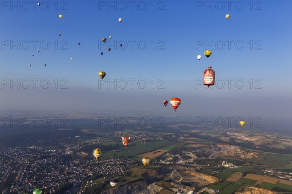 Many different hot air balloons in the blue sky, advertising, logo, hot air balloon festival, 26th Warsteiner International Montgolfiade, evening haze, aerial view, Warstein, Sauerland, North Rhine-Westphalia, Germany, Europe