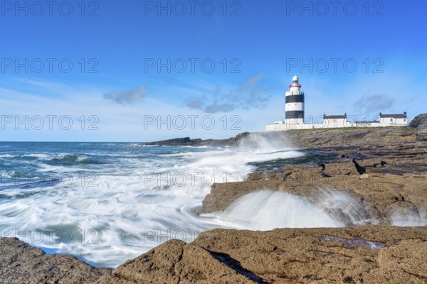 Hook Head lighthouse, blue sky and spray, Wexford, Ireland, Europe