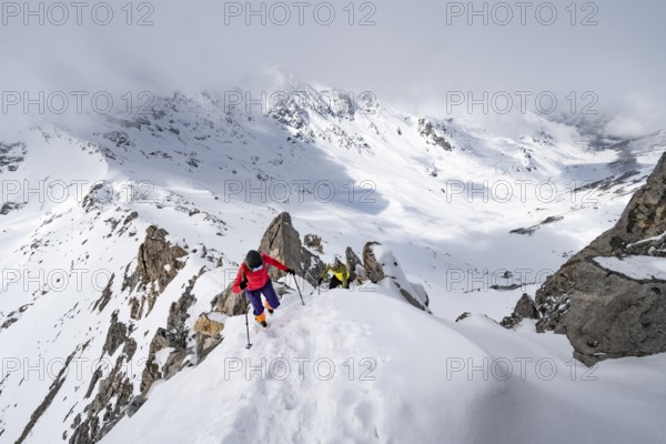 Mountaineer climbing the ridge of Piz Laviner, view of wintry mountain landscape, Grisons Haute Route, Albula Alps, Rhaetian Alps, Grisons, Eastern Switzerland, Switzerland, Europe
