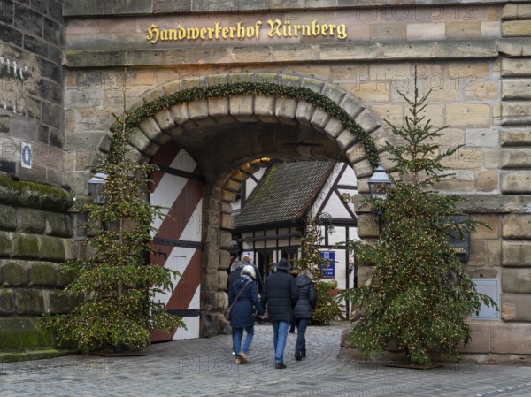 People walking through the Königstor, Christmas trees with fairy lights, Handwerkerhof, Nuremberg, Middle Franconia, Franconia, Bavaria, Germany, Europe