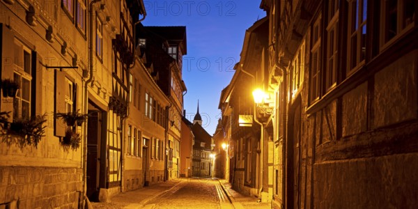 Half-timbered houses in a narrow street with cobblestones, Old Town in the evening, World Heritage City of Quedlinburg, Saxony-Anhalt, Germany, Europe