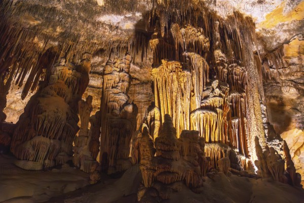 Interior of caves of drach illuminated by colorful lights showing stalactites and stalagmites in mallorca, spain