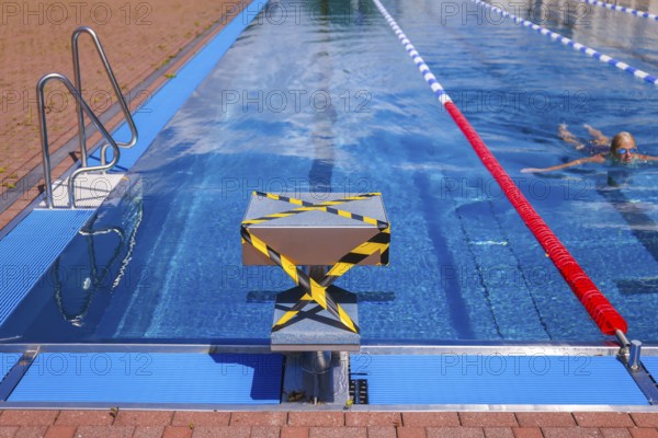 Hagen, North Rhine-Westphalia, Germany - Blocked-off starting block at the edge of the swimming pool in the Hengstey outdoor pool