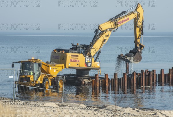 Excavator used in the repair and construction of bathing jetties at Ystads Saltsjöbad, the beach in Ystad, Ystad, Skåne County, Baltic Sea, Sweden, Scandinavia, Europe