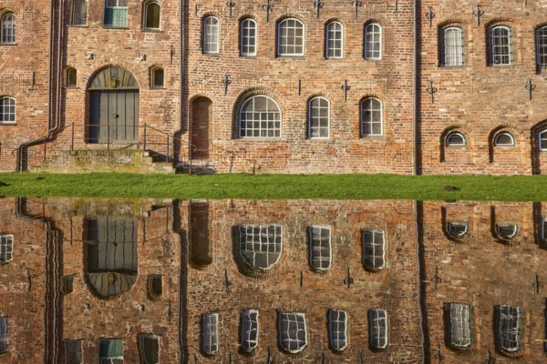 Salt warehouse, historic brick buildings, reflections on the water surface of the Trave, Hanseatic city of Lübeck, independent city, Schleswig-Holstein, Germany, Europe