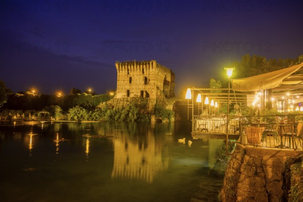 Night shot of restaurant on the Mincio river and Visconti bridge from 1395 in the background, Borghetto, Valeggio sul Mincio, province of Verona, Italy, Europe