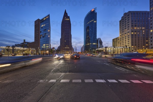 Vehicles with motion blur and light traces, skyscrapers Forum Tower, Kollhoff Tower and railway tower in the blue hour at Potsdamer Platz, dusk in Berlin, capital, independent city, federal state Berlin, Germany, Europe