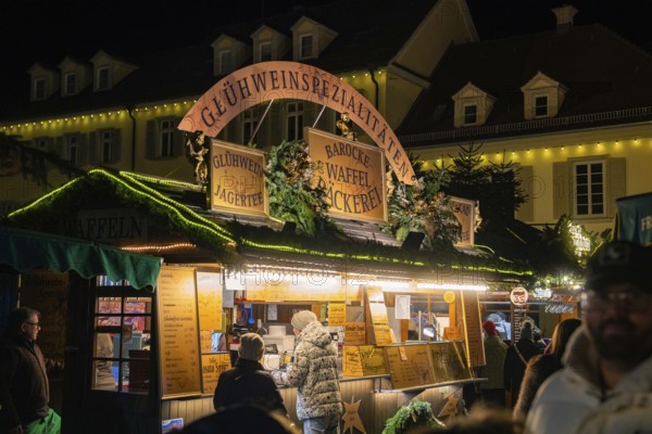 A traditional Christmas market stall in a festive winter atmosphere at night, Christmas market Ludwigsburg, Germany, Europe
