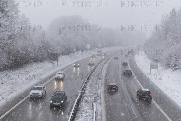 Snowy motorway scene with passing vehicles and dense snow cover, Winnenden, Baden-Württemberg, Germany, Europe