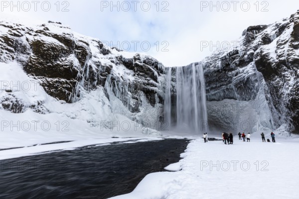 Skogafoss waterfall, snowy and icy rock face, Sudurland, Iceland, Europe
