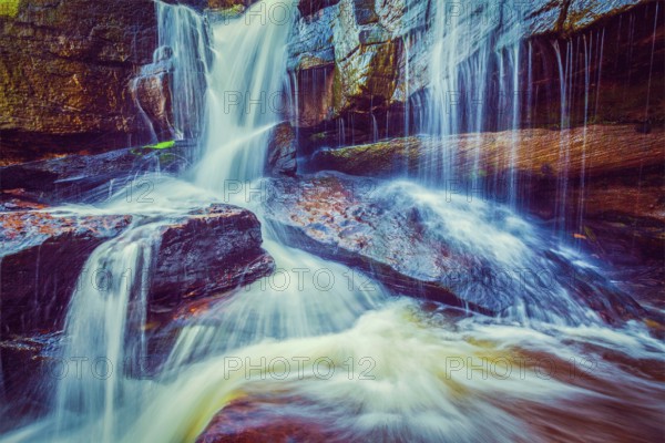 Vintage retro effect filtered hipster style image of tropical waterfall. Popokvil Waterfall, Bokor National Park, Cambodia, Asia