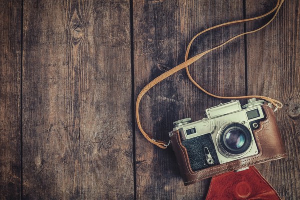 Photography concept background, old retro vintage camera on grunge wooden texture