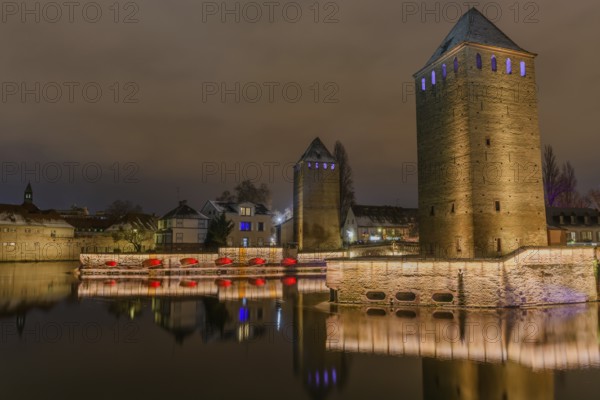The twin watchtowers of the Ponts Couverts were illuminated at night at Christmas. Strasbourg, Bas-Rhin, Alsace, Grand Est, France, Europe