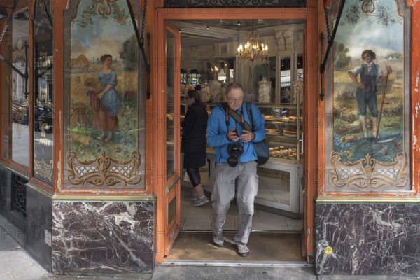 Elderly gentleman comes from a traditional bakery, built around 1900, Paris, France, Europe