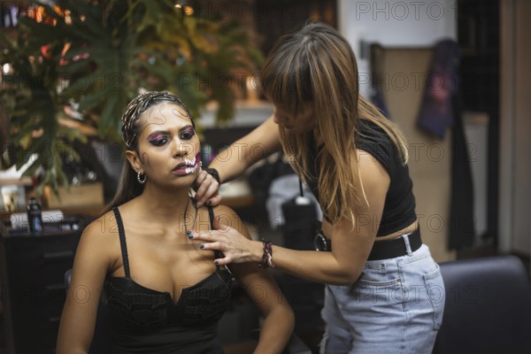 Halloween party hairstyle and makeup preparations, make-up artist making up a woman