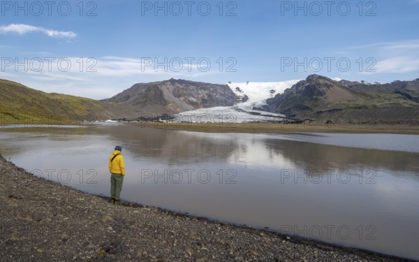 Tourist at the lake, glacier lagoon at the glacier tongue Kvíárjöku, Vatnajökull, Iceland, Europe