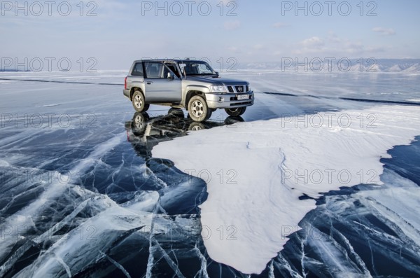 Car on the ice of Lake Baikal, Olkhon Island, Pribaikalsky National Park, Irkutsk Province, Siberia, Russia, Europe